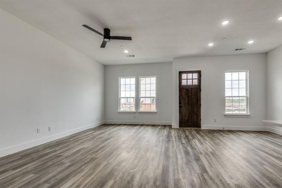 Entryway featuring plenty of natural light, ceiling fan, and light wood-type flooring