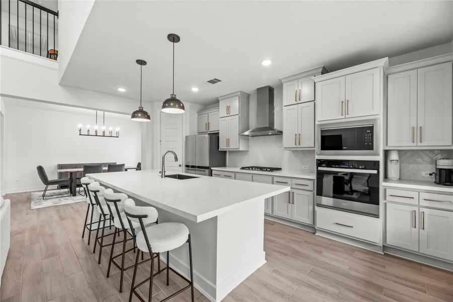 Show off your culinary skills in this fully loaded kitchen, where sleek quartz countertops, designer tile backsplash, and chic finishes set the tone for both entertaining and everyday living. Extensive cabinetry with modern pulls, stainless steel appliances, and a walk-in pantry deliver the perfect blend of style and function.