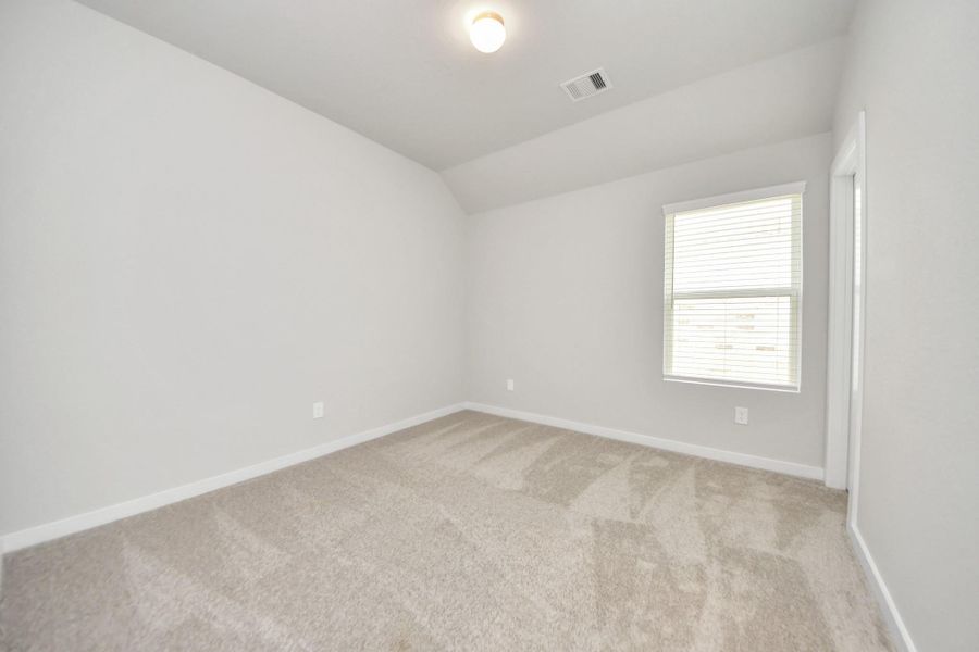 Secondary bedroom features plush carpeting, large windows that let in plenty of natural light, bright paint, and spacious closets. Sample photo of completed home with similar floor plan. Actual colors and selections may vary. Secondary bedroom features plush carpeting, large windows that let in plenty of natural light, bright paint, and spacious closets. Sample photo of completed home with similar floor plan. Actual colors and selections may vary.