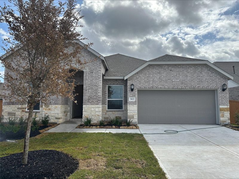 Front exterior of a new home in ARTAVIA, Conroe, TX, highlighting curb appeal (Image 2).