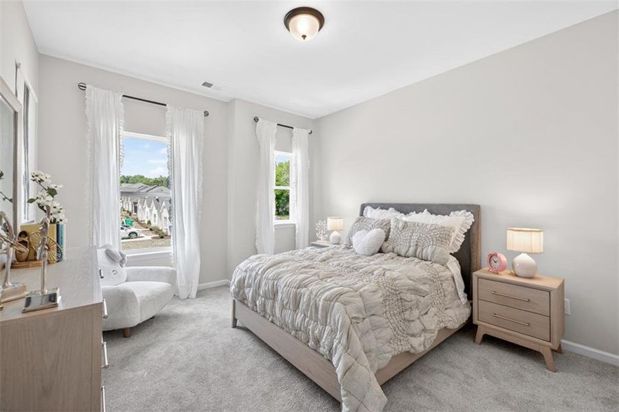 Bright room featuring two large windows with white trim