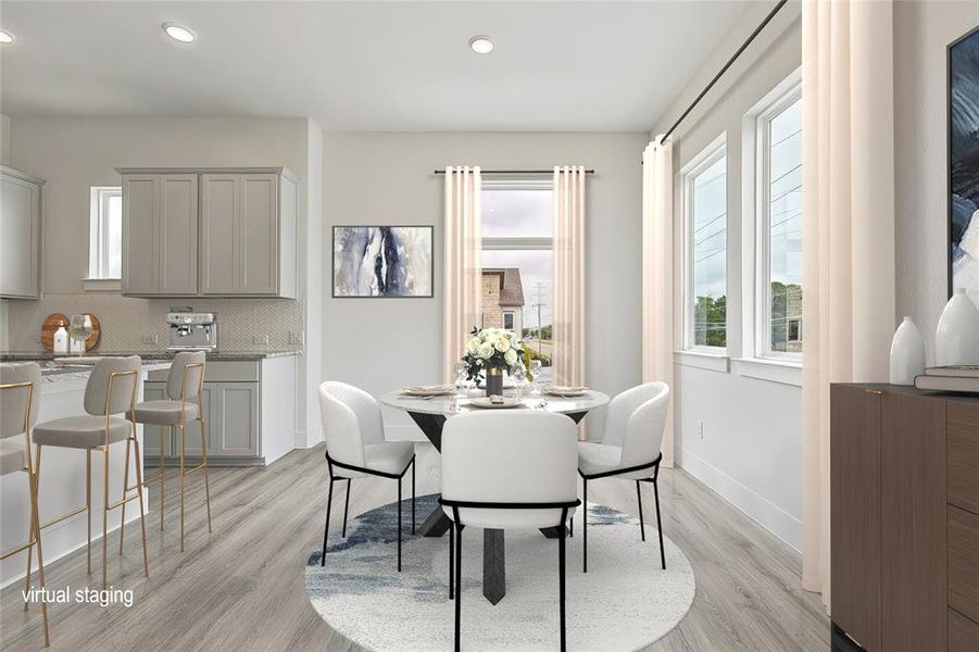 Dining space featuring light wood-type flooring and a healthy amount of sunlight