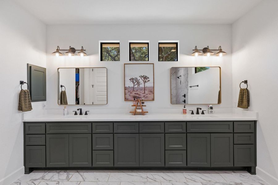 Full bathroom with double vanity and light marble finish flooring
