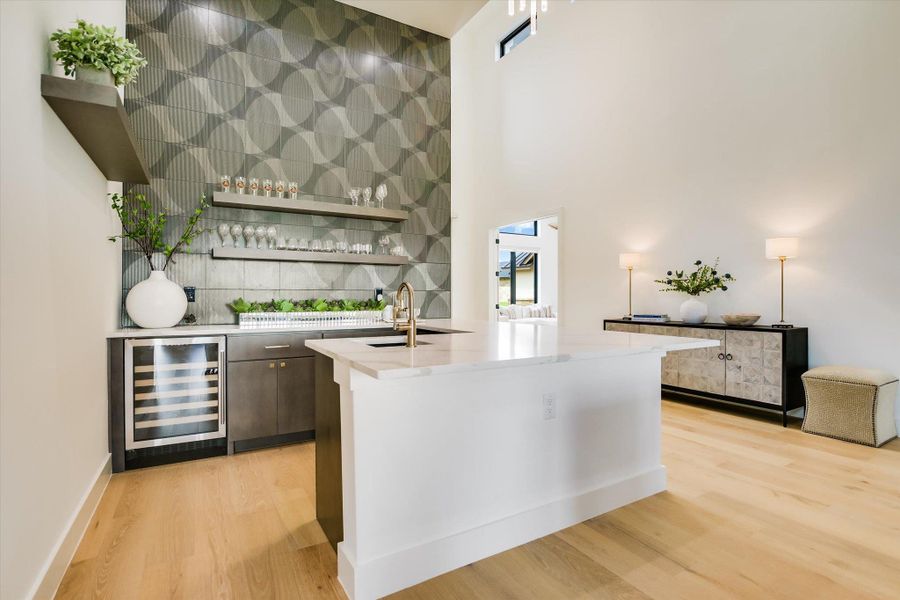 High ceilings and a wet bar create a delightful space for entertaining.