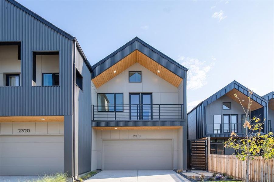 Modern home featuring a garage and a balcony