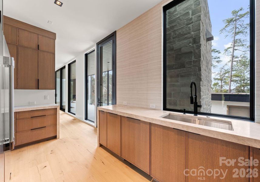 Scullery featuring additional appliances and a walk-in pantry. Scullery featuring additional appliances and a walk-in pantry.