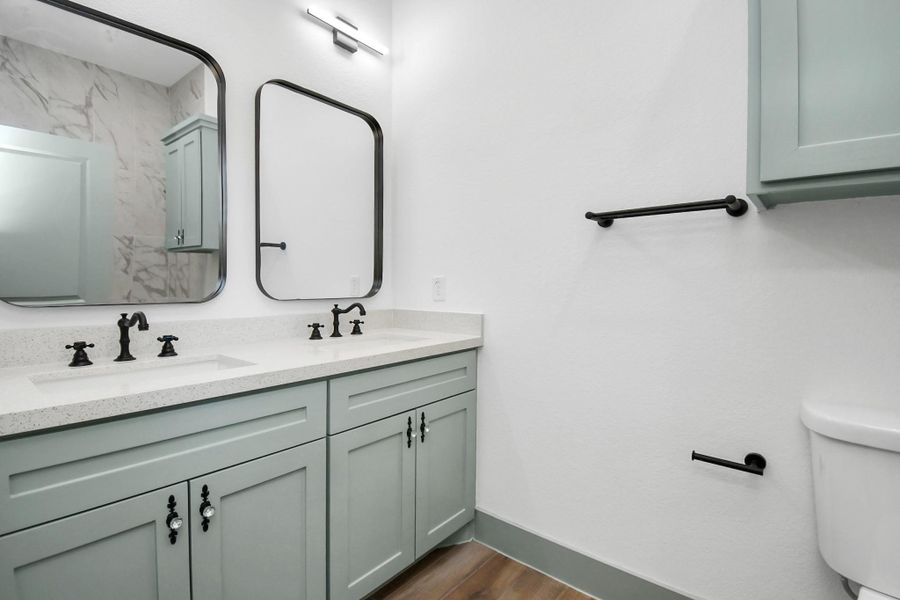 Primary bathroom with dual sinks and a walk in shower. Plus plenty of much needed storage!