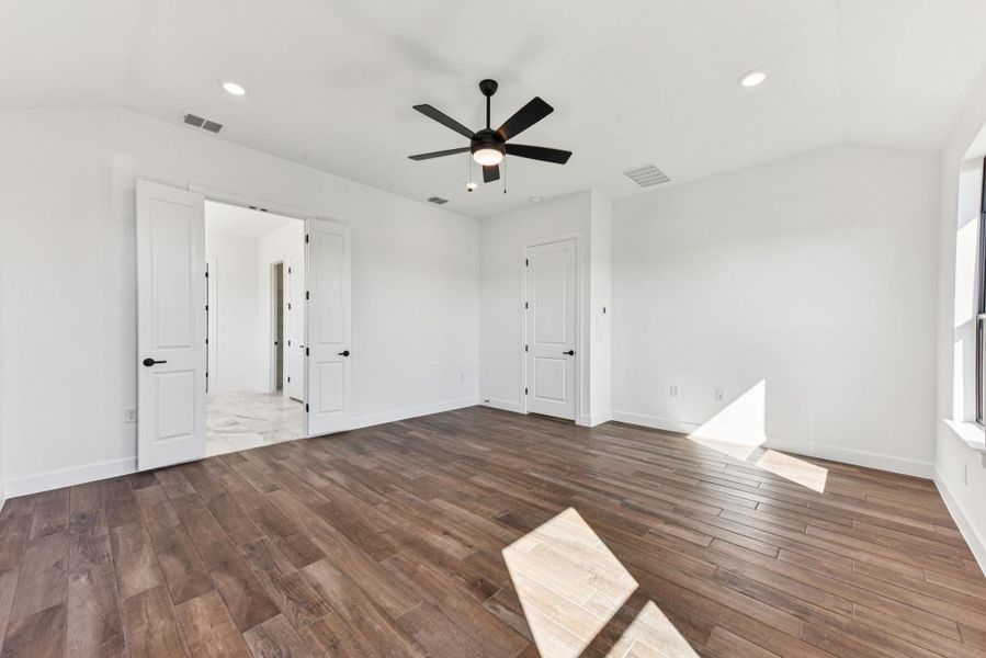 Unfurnished room featuring vaulted ceiling, recessed lighting, wood finished floors, and ceiling fan