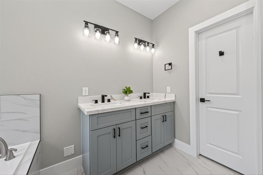 Modern, spa-like primary bathroom with high-end finishes and a clean, elegant design. Black round mirrors are being installed.