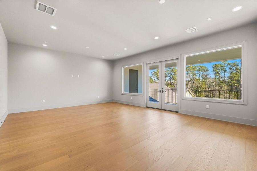 Game room opens up to a second-floor covered veranda with sweeping lake views. Game room opens up to a second-floor covered veranda with sweeping lake views.
