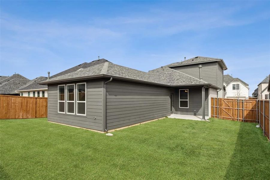 Back of house with a patio area and a yard