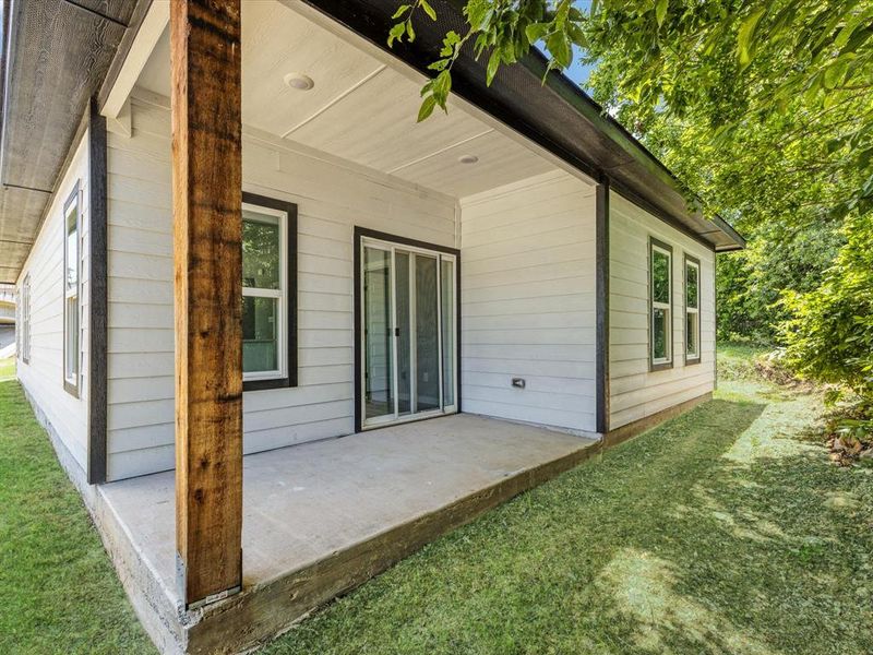 Rear view of house with a patio area and a yard