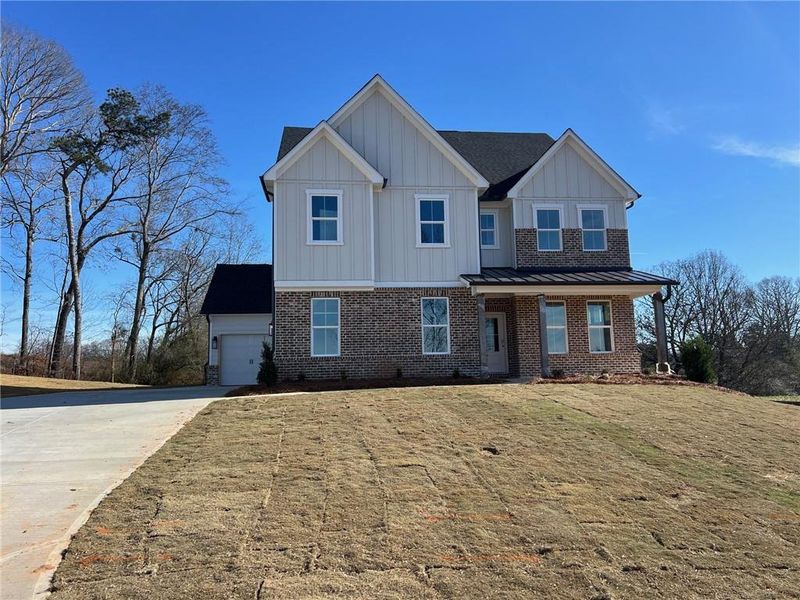 Front exterior of a new home in Acacia, Cumming, GA, highlighting curb appeal (Image 2).