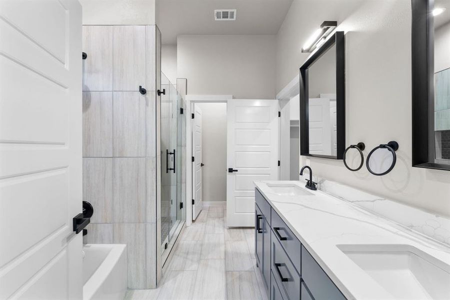 Bathroom featuring vanity and plus walk in shower