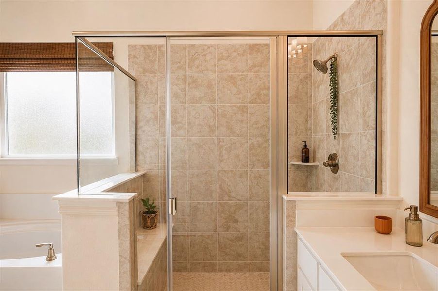 Tiled walk-in shower with glass enclosure, featuring a built-in shelf and bronze-finish fixtures