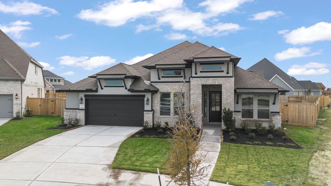 Front exterior of a new home in Valencia, Manvel, TX, highlighting curb appeal (Image 23). Front exterior of a new home in Valencia, Manvel, TX, highlighting curb appeal (Image 23).