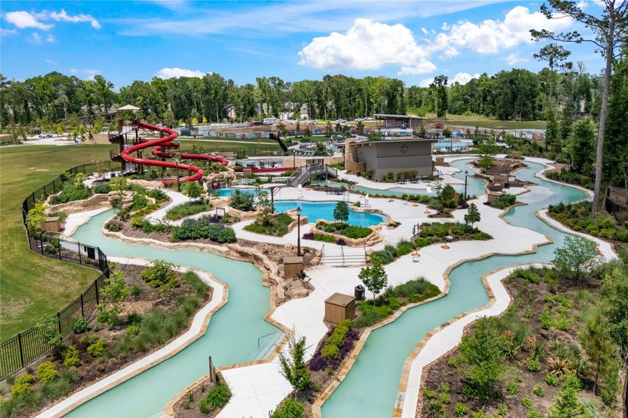 Community water park featuring a winding lazy river and a large pool. Community water park featuring a winding lazy river and a large pool.