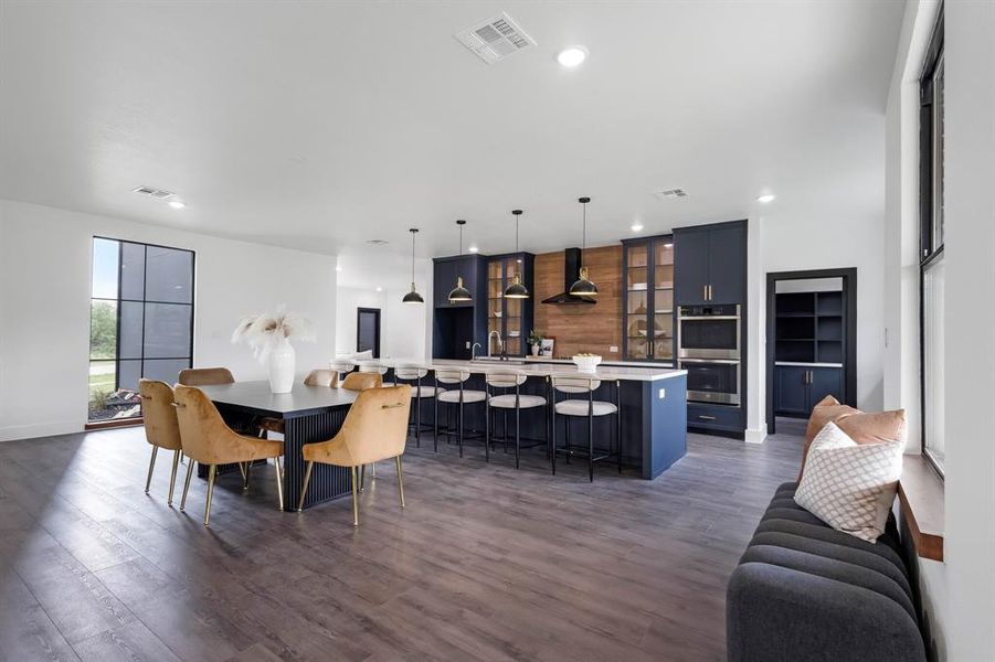 Spacious open-concept interior featuring wood-finish flooring and abundant natural light Spacious open-concept interior featuring wood-finish flooring and abundant natural light