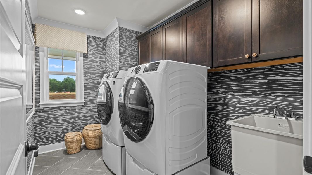 Pelham home plan spacious upstairs laundry room with cabinetry for storage