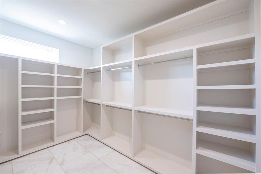 Spacious closet with light tile floors