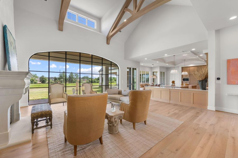 Beautiful view of living room with wall of windows, dormer windows, beamed ceiling and open to large island kitchen with beautiful breakfast room/informal dining with wall of windows. Beautiful view of living room with wall of windows, dormer windows, beamed ceiling and open to large island kitchen with beautiful breakfast room/informal dining with wall of windows.