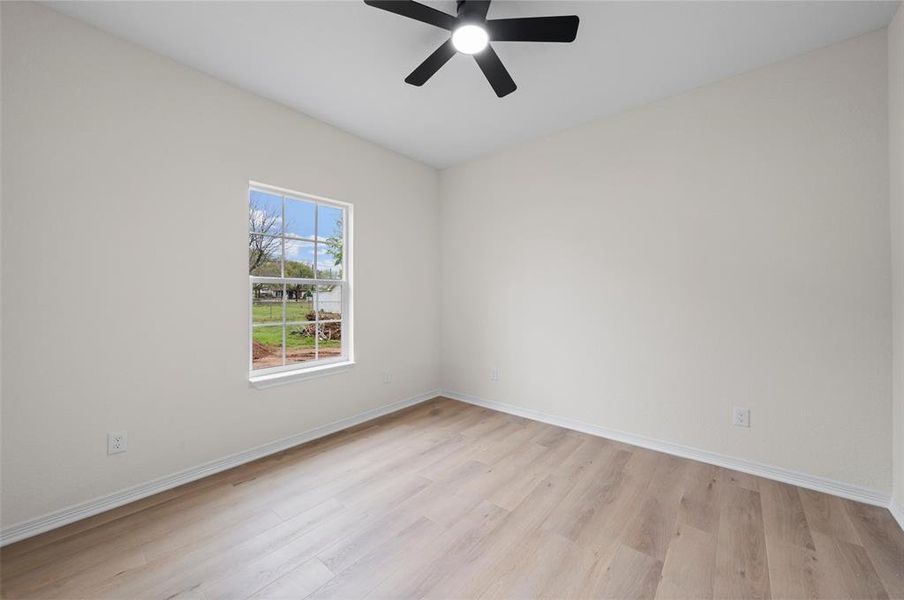 Spare room with light wood-style flooring and ceiling fan