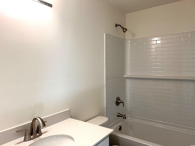 Bathroom with shower / tub combination and vanity