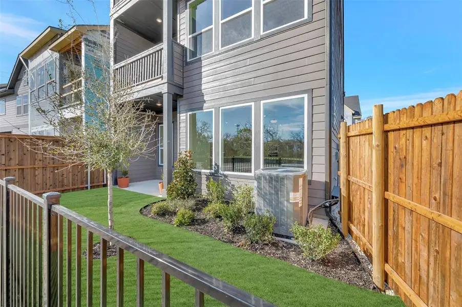 Back of house featuring a balcony and a fenced backyard Back of house featuring a balcony and a fenced backyard