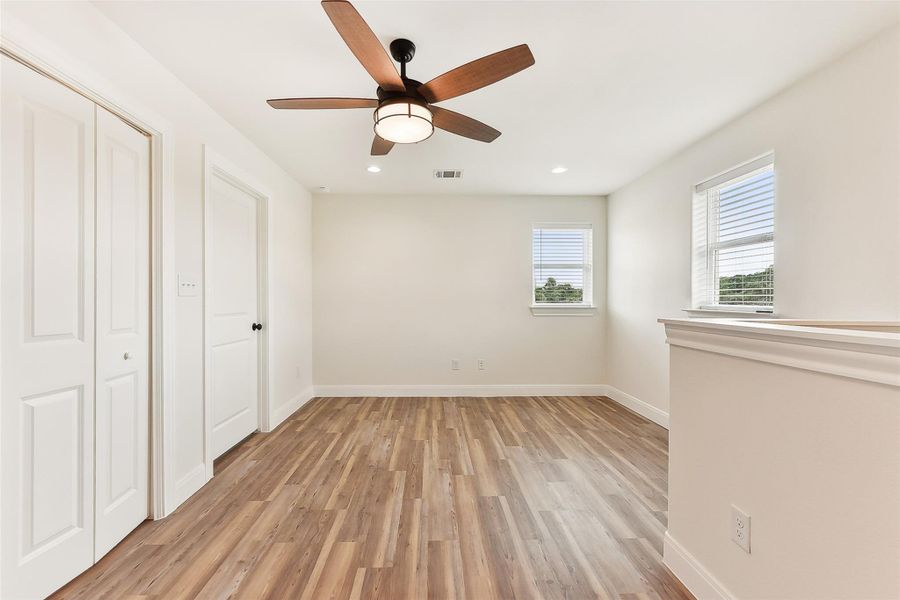 Upstairs Family Area with light wood-type flooring, baseboards, recessed lighting, a ceiling fan, and a closet Upstairs Family Area with light wood-type flooring, baseboards, recessed lighting, a ceiling fan, and a closet
