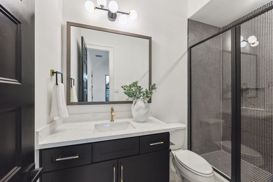 This secondary bathroom features a walk-in shower This secondary bathroom features a walk-in shower