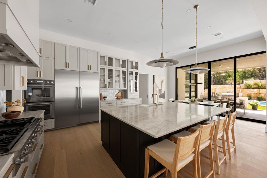 A chef’s masterclass in design: premium stainless appliances, a professional-grade gas cooktop, and a seamlessly integrated drawer microwave