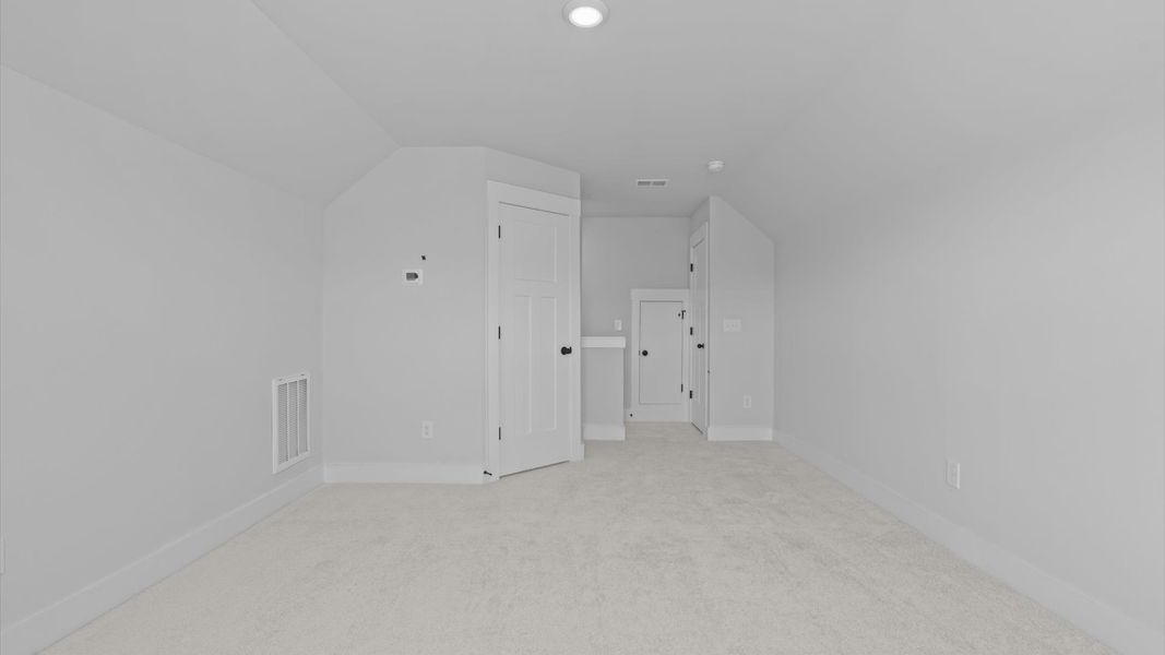 First-class secondary bedroom with comfortable carpeted flooring and generous closet space