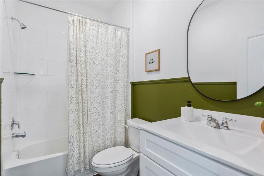 Full bathroom downstairs has been updated with chair rail and modern bathroom mirrors.