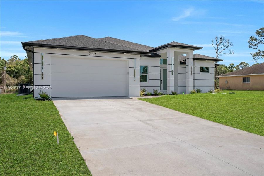 Front exterior of a new home in , Lehigh Acres, FL, highlighting curb appeal (Image 28). Front exterior of a new home in , Lehigh Acres, FL, highlighting curb appeal (Image 28).