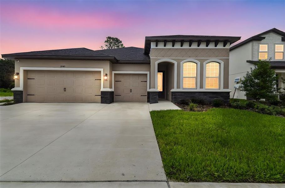 Front exterior of a new home in Hidden Ridge, New Port Richey, FL, highlighting curb appeal (Image 25).