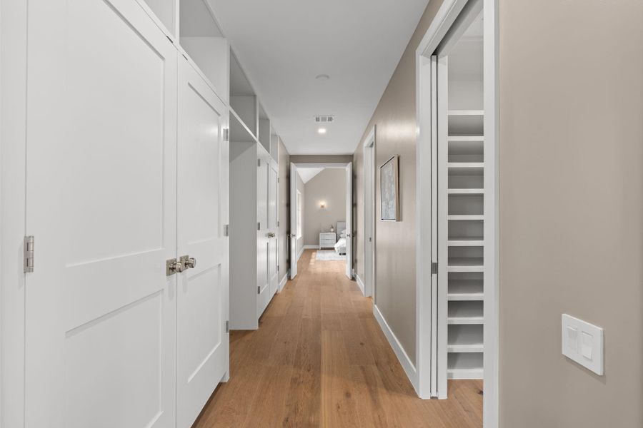 entry to primary suite, three closets and tons of built ins