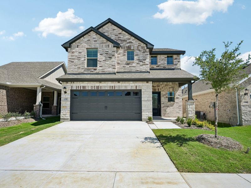 Front exterior of a new home in Parks at Foster Crossing - Spring Series, Anna, TX, highlighting curb appeal (Image 1). Front exterior of a new home in Parks at Foster Crossing - Spring Series, Anna, TX, highlighting curb appeal (Image 1).