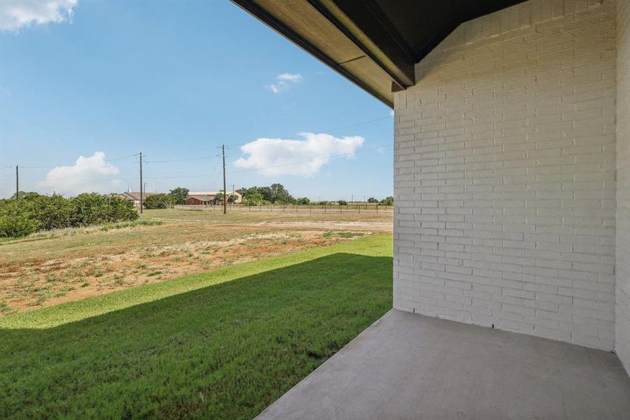 View of yard featuring a rural view and a patio area