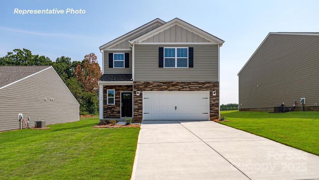 Front exterior of a new home in Reedy Creek Preserve, Charlotte, NC, highlighting curb appeal (Image 1).