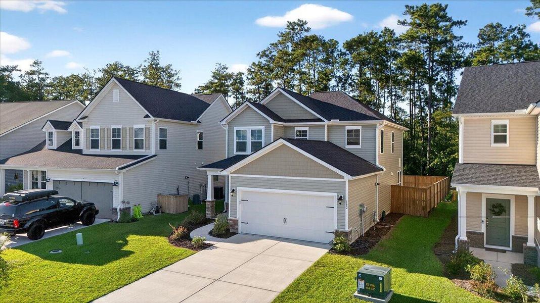 Front exterior of a new home in Jasmine Point at Lakes of Cane Bay, Summerville, SC, highlighting curb appeal (Image 21).