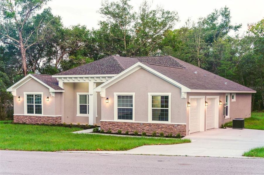 Front exterior of a new home in , Summerfield, FL, highlighting curb appeal (Image 19). Front exterior of a new home in , Summerfield, FL, highlighting curb appeal (Image 19).