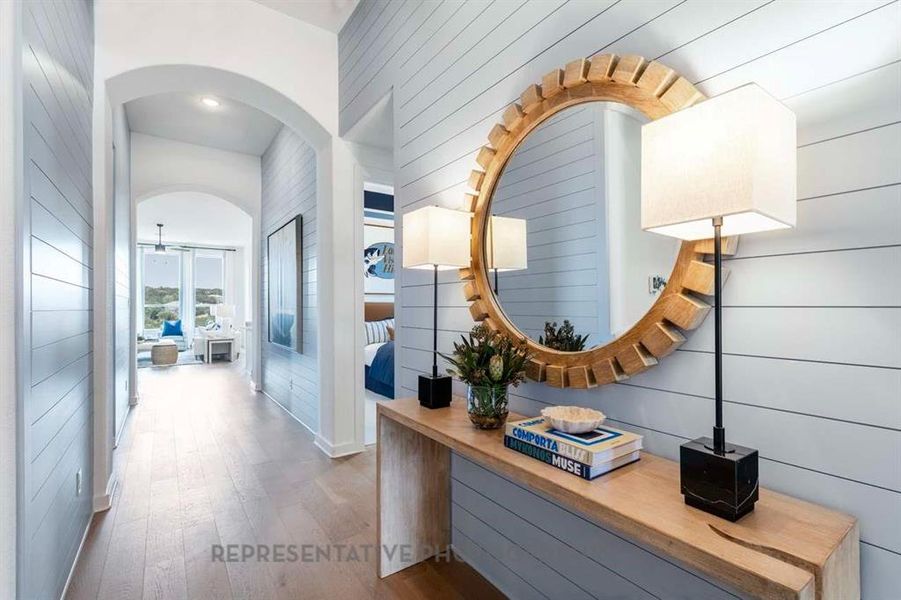 Corridor with wood finished floors, arched walkways, and wood walls Corridor with wood finished floors, arched walkways, and wood walls