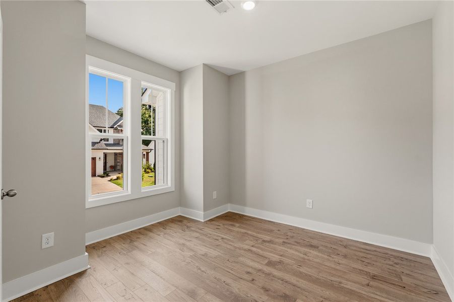 Hardwood flooring extends through this naturally i