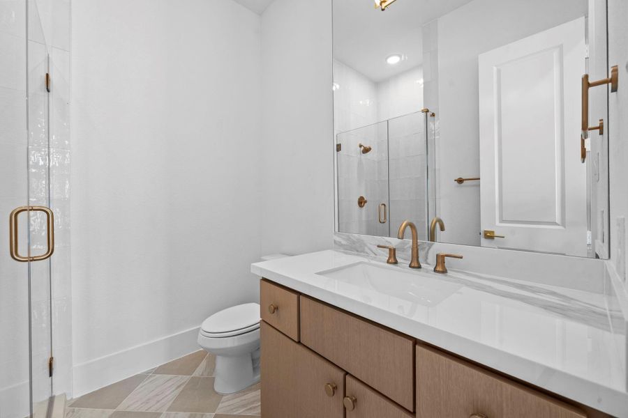 Elegant bathroom featuring glass enclosed shower, refined finishes, and a spacious layout.