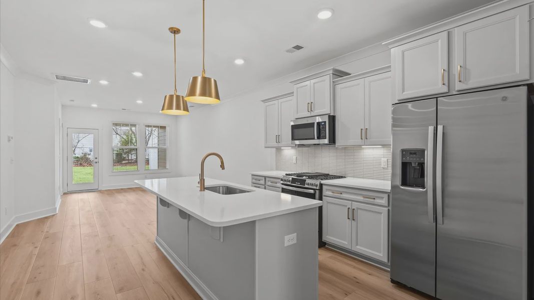 Well-designed kitchen with a center island and tasteful finishes that elevate everyday living at Pelham Crossing