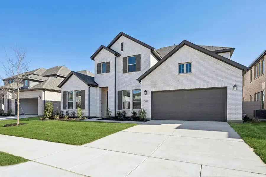 Front exterior of a new home in Painted Tree Lakeside, McKinney, TX, highlighting curb appeal (Image 2). Front exterior of a new home in Painted Tree Lakeside, McKinney, TX, highlighting curb appeal (Image 2).