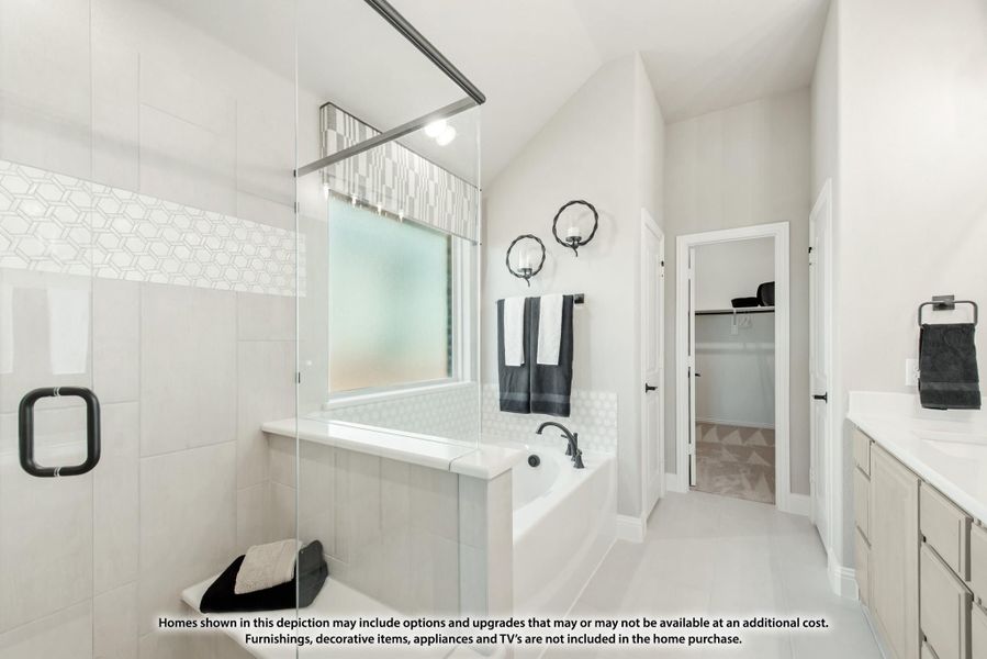 Master bathroom with glass walk-in shower, soaking tub, dual vanity, and walk-in closet entrance Master bathroom with glass walk-in shower, soaking tub, dual vanity, and walk-in closet entrance