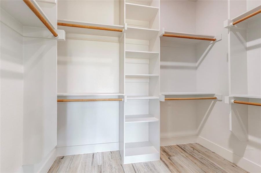 Spacious closet featuring light wood-type flooring