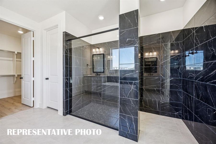 You'll enjoy a spa like experience every day in this spacios owner's bath walk in shower with optional drying area! REPRESENTATIVE PHOTO