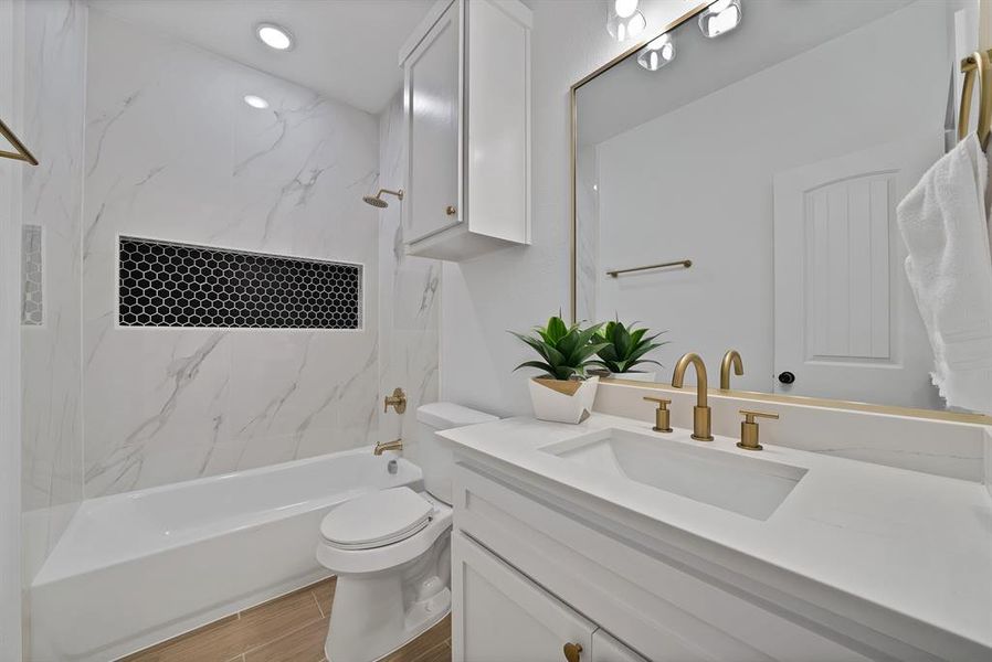 Bathroom featuring vanity, washtub / shower combination.